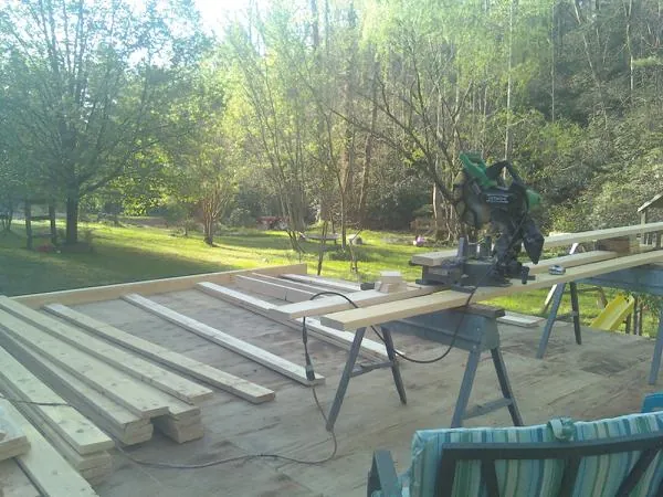 Miter saw and framing lumber on a deck under construction in Junction City